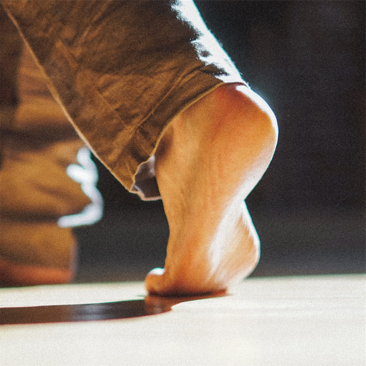 A close up of a dancers planted back foot.