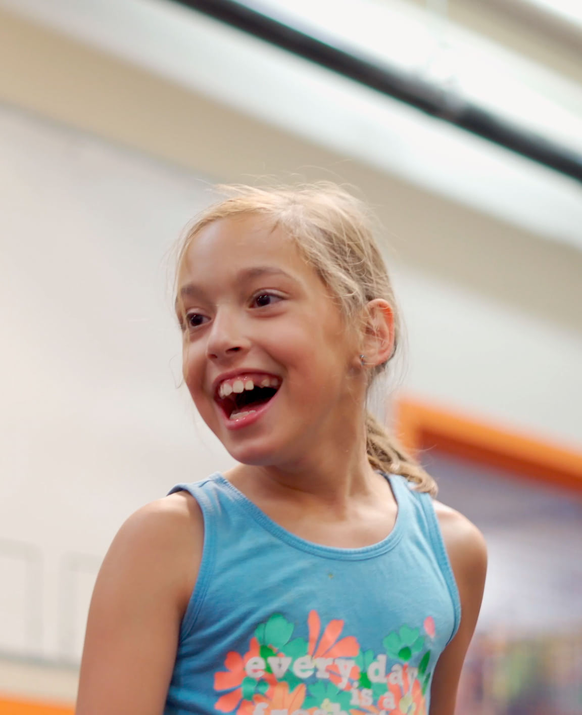 Portrait of a young child smiling and excited.