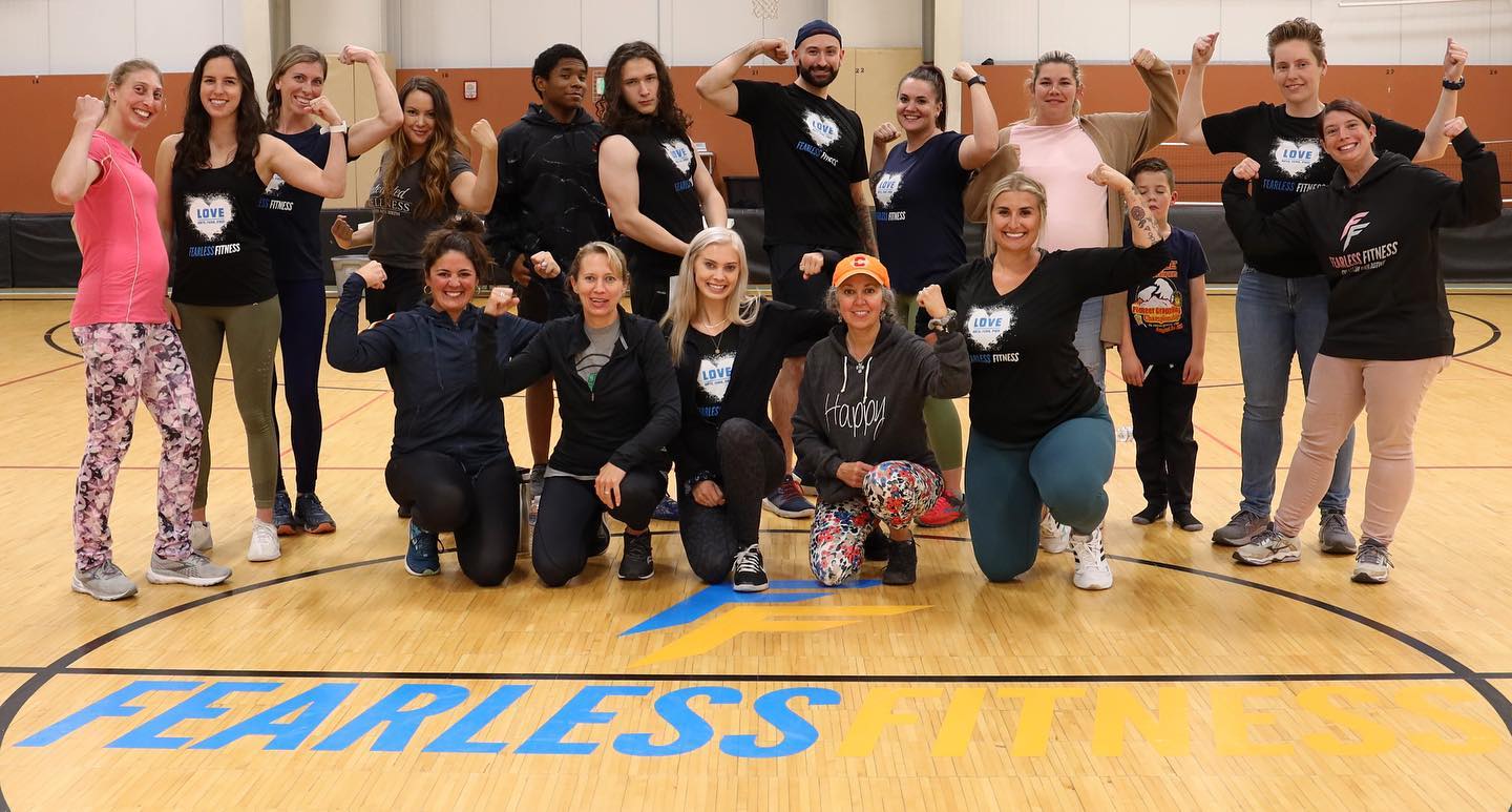 The fearless fitness team and members flexing and posing for a photo.
